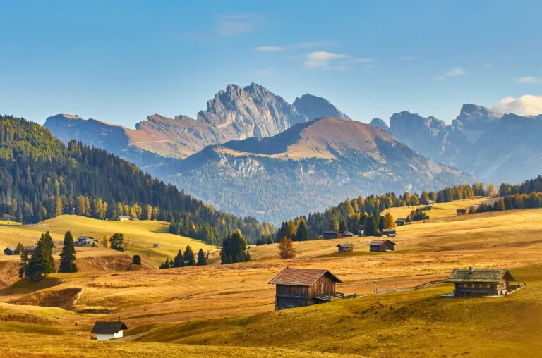 Beautiful sunrise view of meadow Seiser Alm Alpe di Siusi with Odle - Geisler mountain group on background. Morning autumn scenery in Dolomite Alps, Italy.